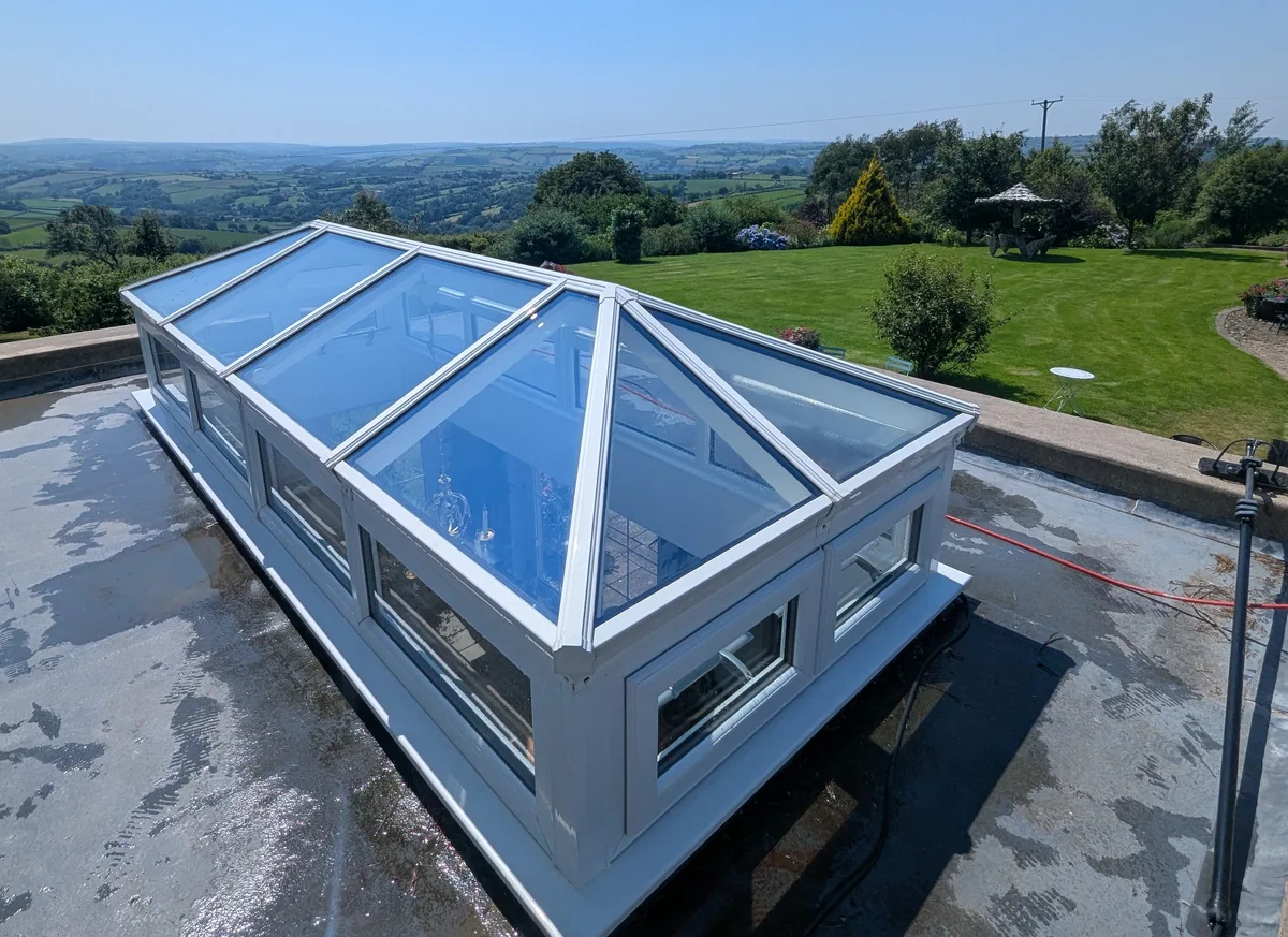 Freshly cleaned lantern roof skylight overlooking open countryside